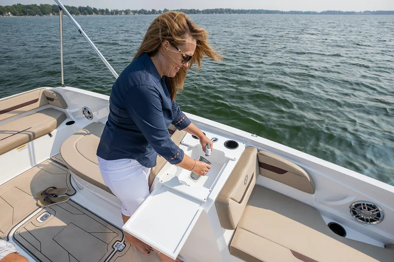 Slide: The Image of Woman relaxing on 2025 Hurricane SunDeck Sport 205 OB boat in sunny weather. - 22