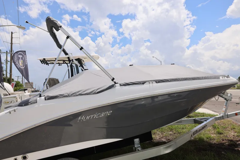 Slide: The Image of 2026 Hurricane SunDeck Sport 205 OB boat dashboard with steering wheel and control panel. - 6