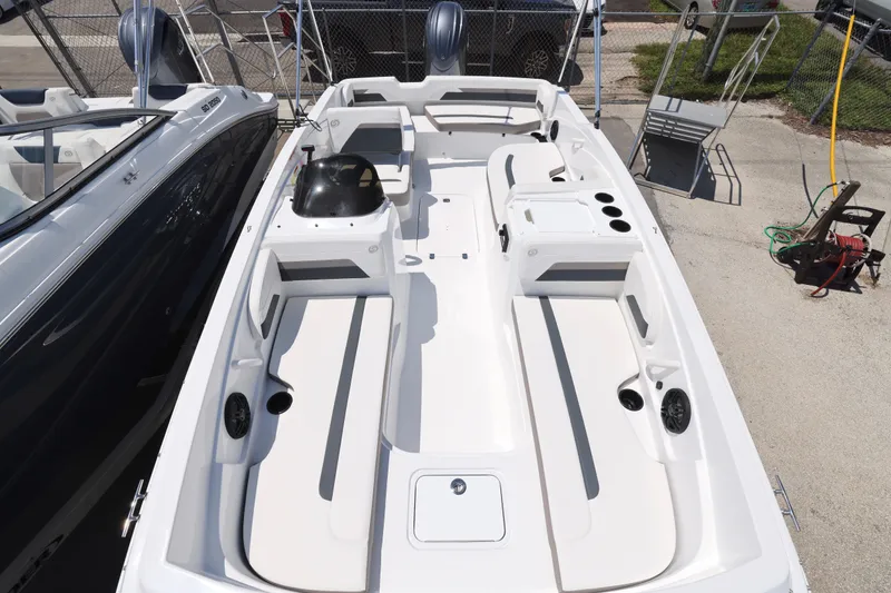 Slide: The Image of 2026 Hurricane SunDeck Sport 205 OB boat with cover on trailer, under a partly cloudy sky. - 7