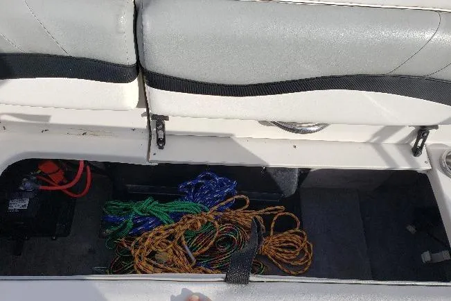 Slide: The Image of Storage compartment in a 2015 Starcraft Limited 2000 IO boat with ropes and battery. - 15