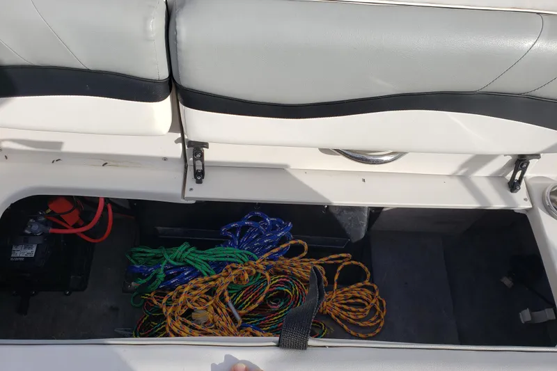 Slide: The Image of Storage compartment of a 2015 Starcraft Limited 2000 IO boat with colorful ropes. - 19