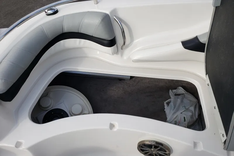 Slide: The Image of Interior of a 2015 Starcraft Limited 2000 IO boat, featuring seating and storage area. - 23