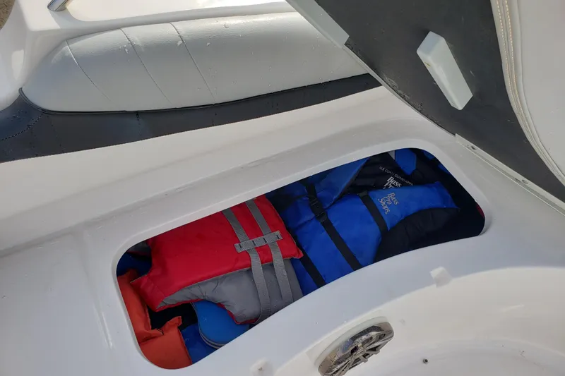 Slide: The Image of Storage compartment in a 2015 Starcraft Limited 2000 IO boat with life jackets. - 24