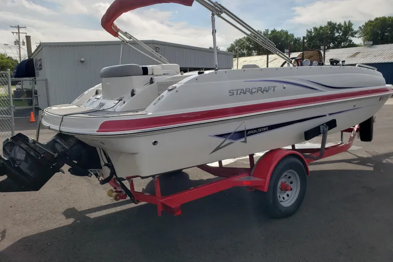 Slide: The Image of 2015 Starcraft Limited 2000 IO boat on red trailer, parked outdoors. - 3