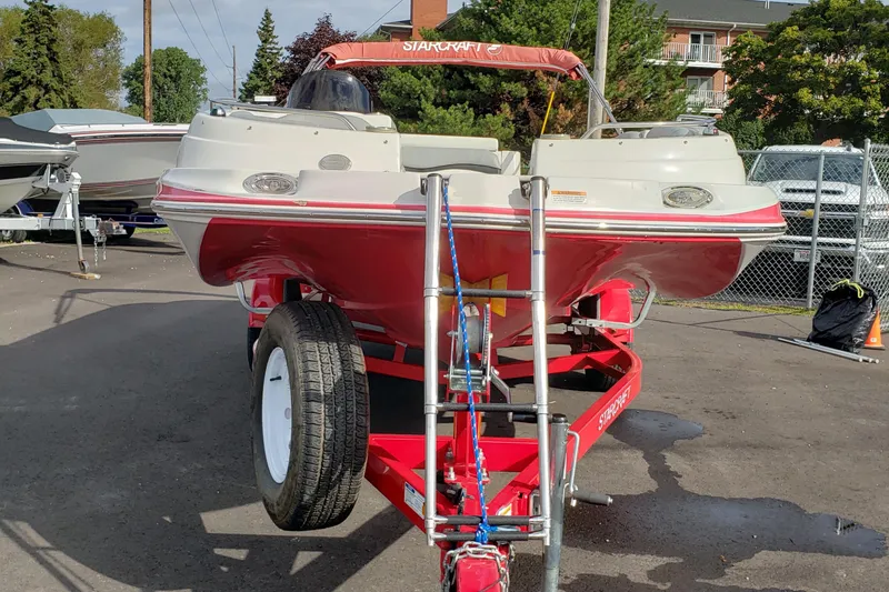 Slide: The Image of 2015 Starcraft Limited 2000 IO boat on trailer, parked outdoors. - 4