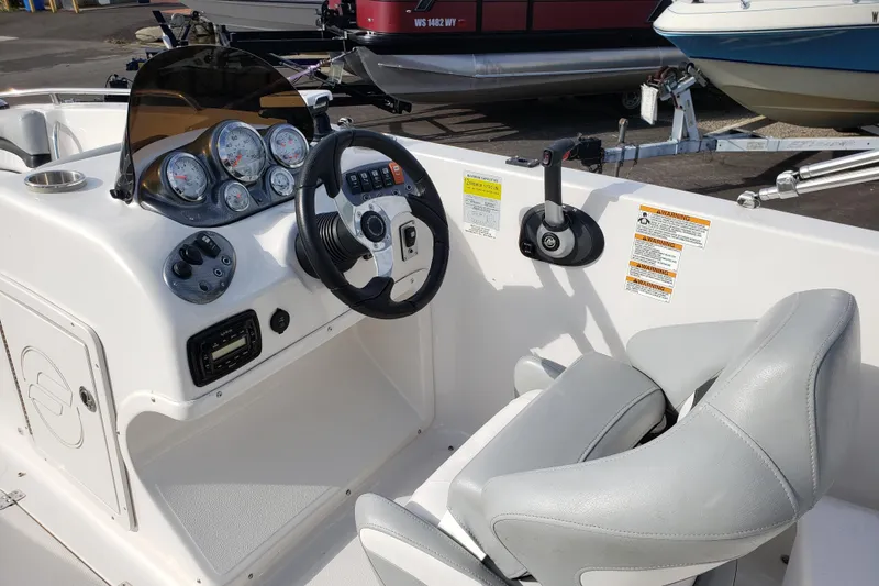 Slide: The Image of 2015 Starcraft Limited 2000 IO boat dashboard with steering wheel and gauges. - 5