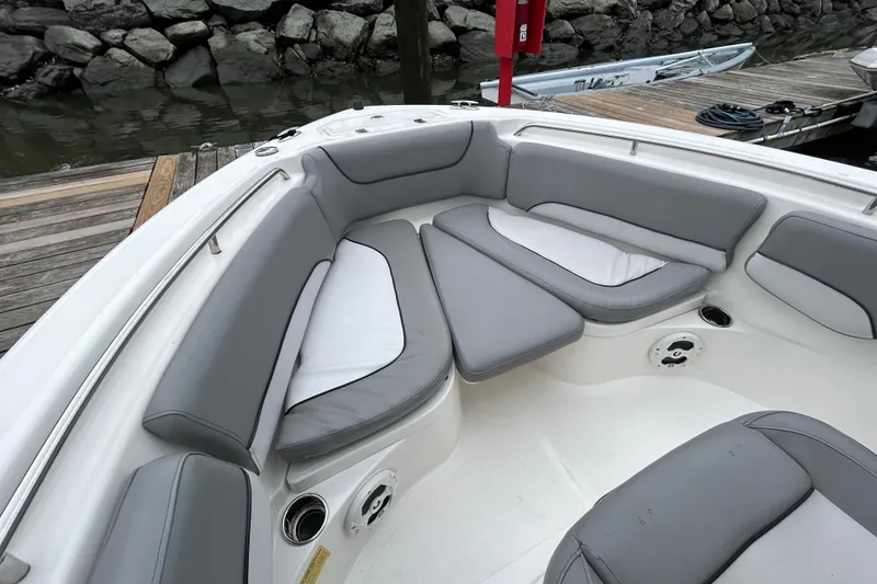 Slide: The Image of 2021 NauticStar 2102 Legacy boat with gray cushioned seating at dockside. - 14