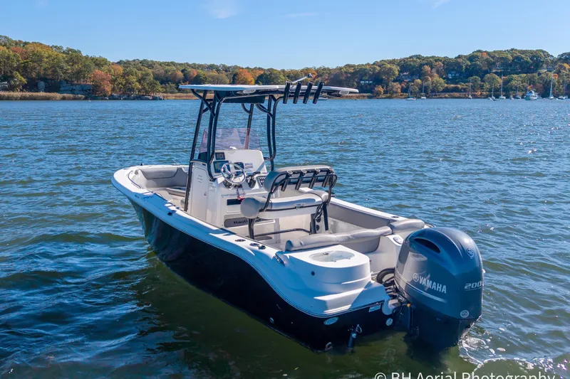 Slide: The Image of 2021 NauticStar 2102 Legacy boat on a scenic lake with Yamaha engine. - 2