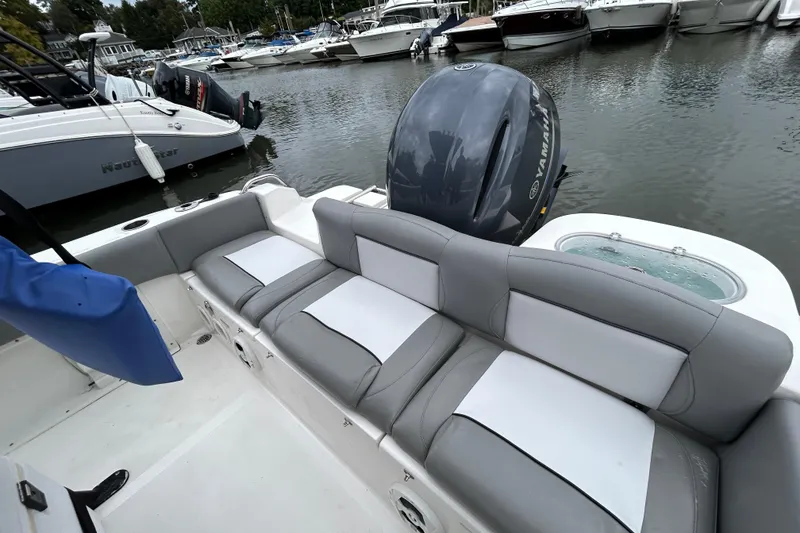 Slide: The Image of 2021 NauticStar 2102 Legacy boat interior with Yamaha engine at marina. - 20