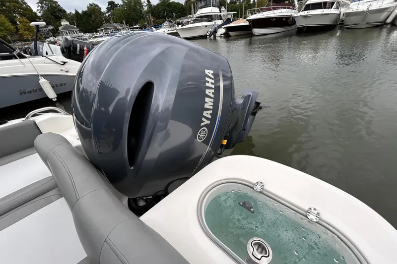 Slide: The Image of 2021 NauticStar 2102 Legacy with Yamaha outboard motor docked at marina. - 21