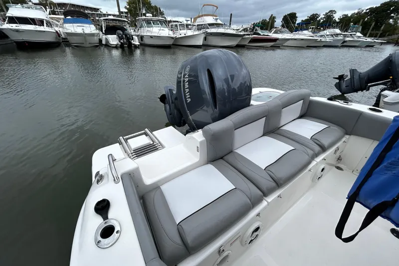 Slide: The Image of 2021 NauticStar 2102 Legacy boat with Yamaha engine, docked among other boats. - 23