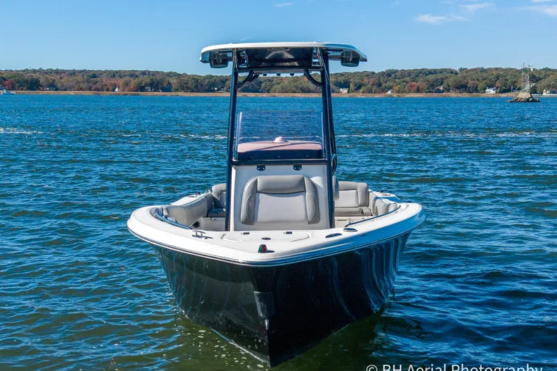 Slide: The Image of 2021 NauticStar 2102 Legacy boat on calm water, clear sky background. - 5