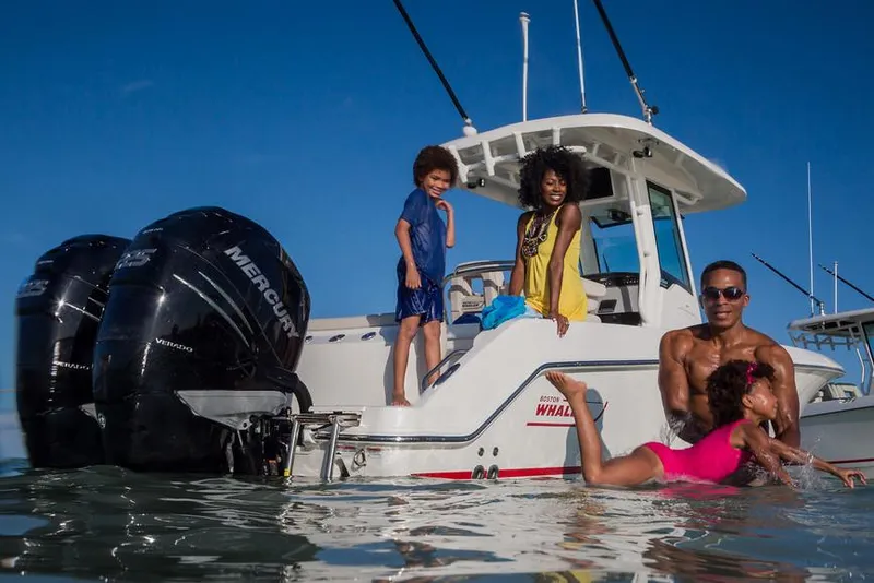 Slide: The Image of Manufacturer Provided Image: Family enjoying water activities near a 2017 Boston Whaler 250 Outrage boat. - 4