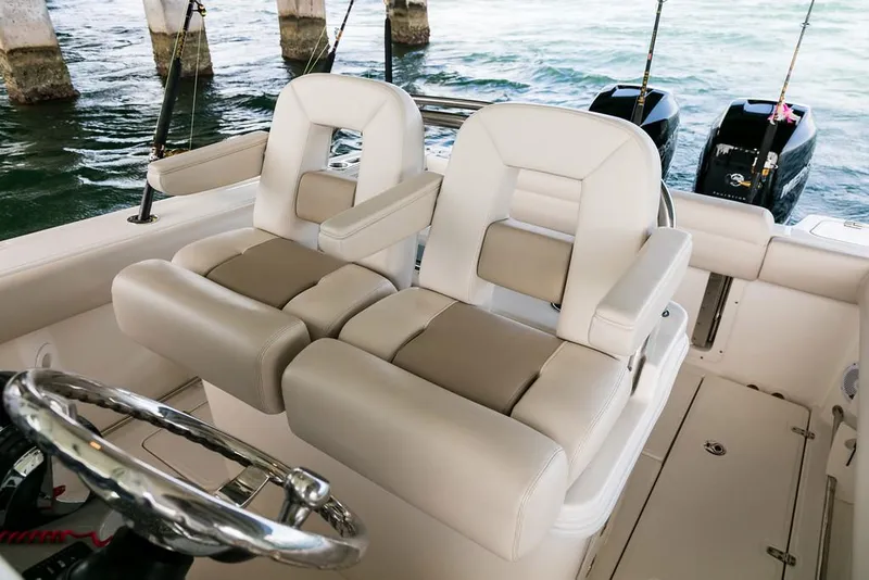 Slide: The Image of Manufacturer Provided Image: 2017 Boston Whaler 250 Outrage boat interior with dual captain's chairs and steering wheel. - 9