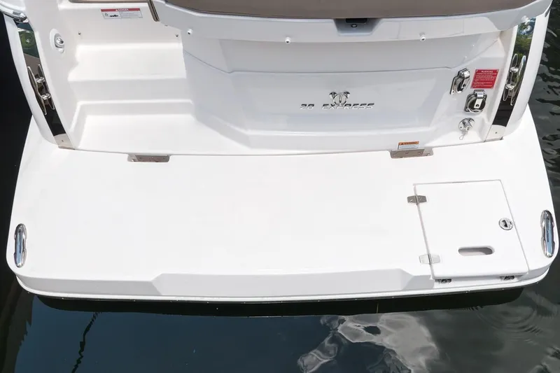 Slide: The Image of 2019 Regal 28 Express boat stern with swim platform and storage hatch. - 10