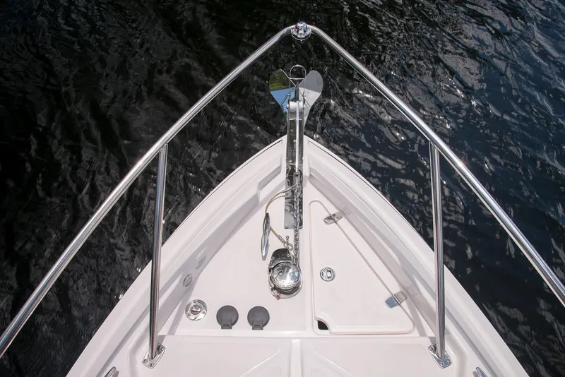 Slide: The Image of Bow of 2019 Regal 28 Express boat with anchor over water. - 5