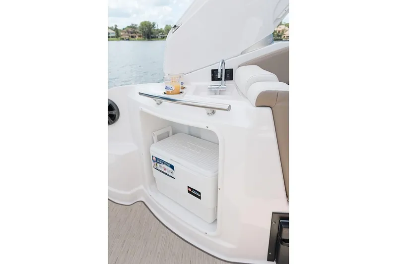 Slide: The Image of 2019 Regal 28 Express boat interior with cooler storage and seating. - 8