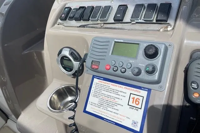 Slide: The Image of Control panel of 2011 Cruisers Yachts 360 Express with radio and emergency procedures. - 15