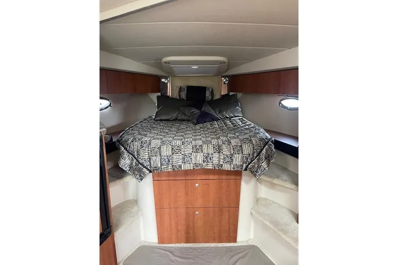 Slide: The Image of 2011 Cruisers Yachts 360 Express cabin interior with bed and wooden cabinetry. - 21