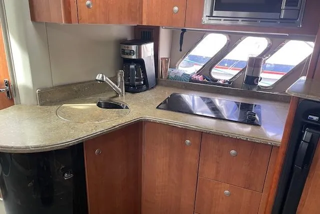 Slide: The Image of 2011 Cruisers Yachts 360 Express kitchen with sink, stove, and coffee maker. - 25