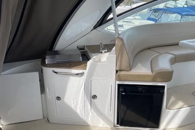Slide: The Image of Interior of 2011 Cruisers Yachts 360 Express with seating and kitchenette area. - 27
