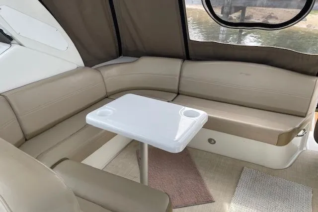 Slide: The Image of 2011 Cruisers Yachts 360 Express interior with beige seating and white table. - 28