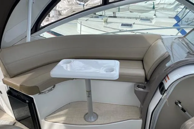 Slide: The Image of Interior of 2011 Cruisers Yachts 360 Express with beige seating and a small table. - 30