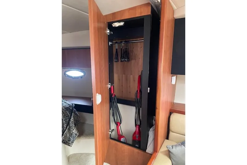 Slide: The Image of 2011 Cruisers Yachts 360 Express interior closet with vacuum and hangers. - 33