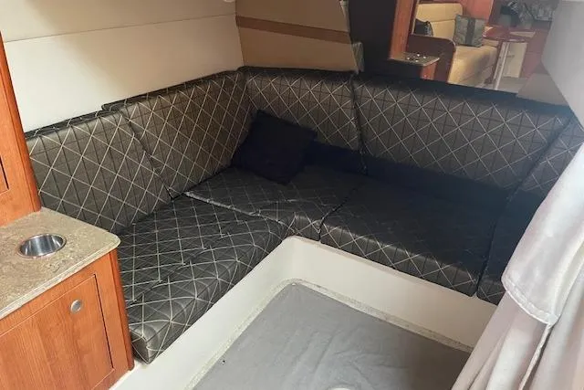 Slide: The Image of Interior of 2011 Cruisers Yachts 360 Express with cushioned seating and wooden cabinetry. - 36