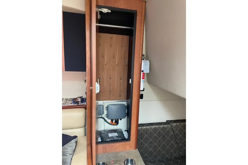 Slide: The Image of Interior of 2011 Cruisers Yachts 360 Express, featuring a wooden cabinet and seating area. - 38