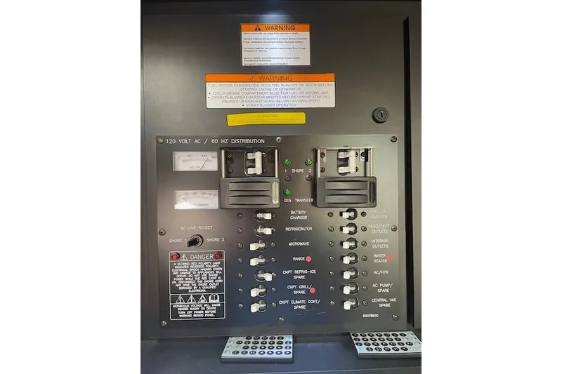 Slide: The Image of Electrical panel of 2011 Cruisers Yachts 360 Express with warning labels and switches. - 43