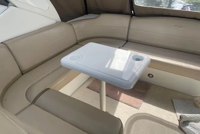 Slide: The Image of 2011 Cruisers Yachts 360 Express interior with beige seating and a white table. - 6