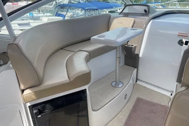 Slide: The Image of 2011 Cruisers Yachts 360 Express interior with beige seating and compact table. - 8