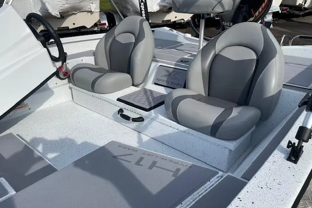 Slide: The Image of 2023 Xpress H17 boat interior with dual gray seats and steering wheel. - 3