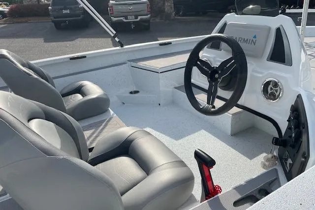 Slide: The Image of 2023 Xpress H17 boat interior with steering wheel and seating, featuring Garmin equipment. - 4