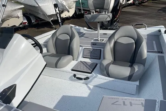 Slide: The Image of 2023 Xpress H17 boat interior with dual gray seats and steering console. - 6