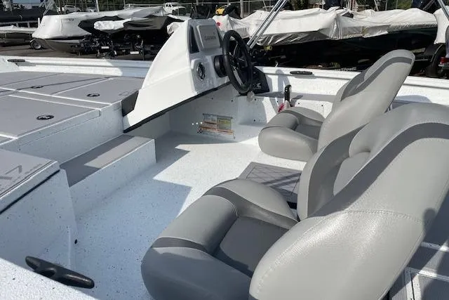 Slide: The Image of 2023 Xpress H17 boat interior with gray seating and steering console. - 7