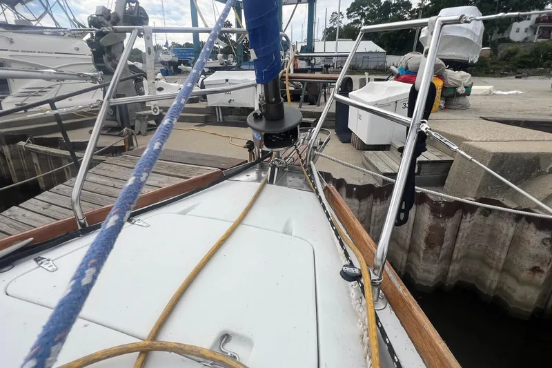 Slide: The Image of 1985 C&C Landfall 39 sailboat docked, showing deck and rigging details. - 17
