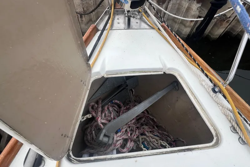 Slide: The Image of Open anchor locker on 1985 C&C Landfall 39 sailboat, showing ropes and anchor. - 18