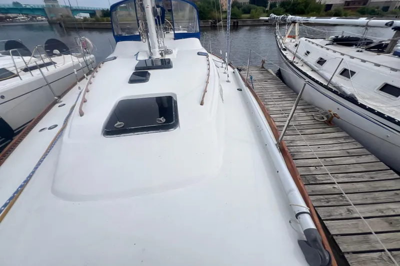 Slide: The Image of 1985 C&C Landfall 39 sailboat docked, showcasing deck and hatches. - 19