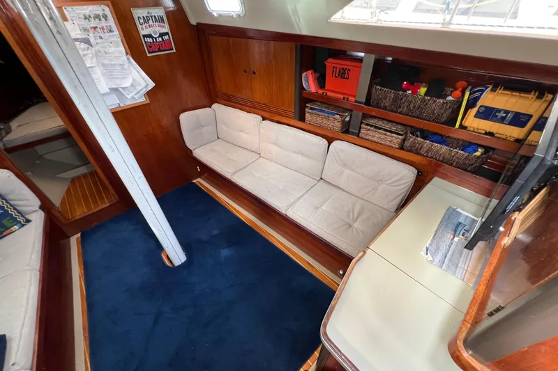 Slide: The Image of Interior of 1985 C&C Landfall 39 sailboat with cozy seating and storage. - 25