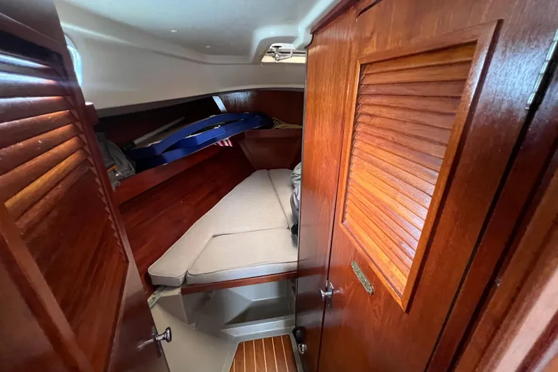 Slide: The Image of Cozy cabin interior of 1985 C&C Landfall 39 sailboat with wooden finish and cushioned berth. - 31