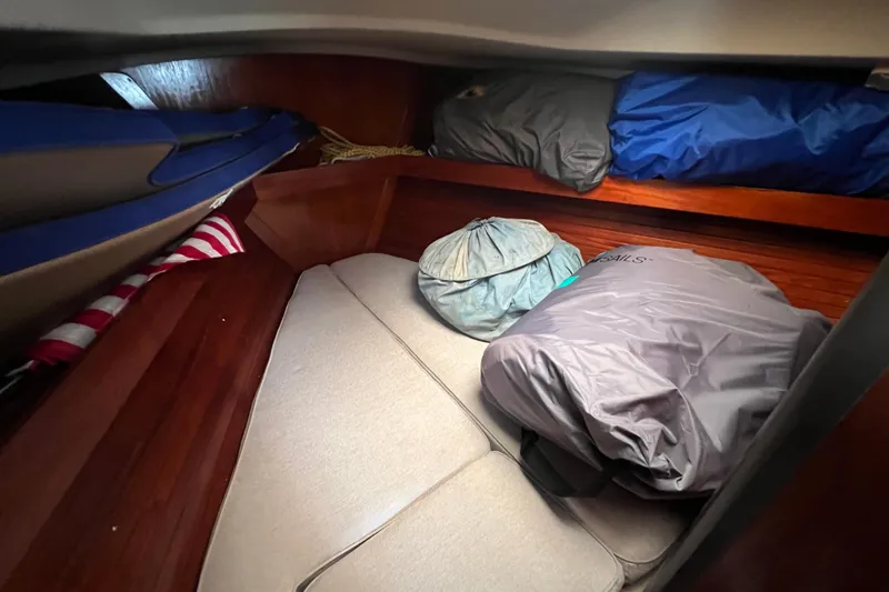 Slide: The Image of Interior cabin of 1985 C&C Landfall 39 sailboat with cushions and stored gear. - 32