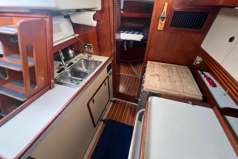Slide: The Image of 1985 C&C Landfall 39 yacht interior with kitchen, sink, and wooden cabinetry. - 37