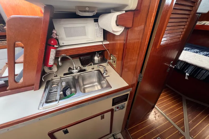 Slide: The Image of 1985 C&C Landfall 39 yacht interior with kitchenette, sink, and microwave. - 38