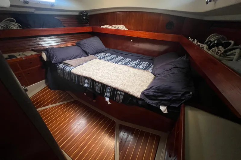 Slide: The Image of Cozy cabin interior of 1985 C&C Landfall 39 sailboat with wooden finish and bedding. - 40