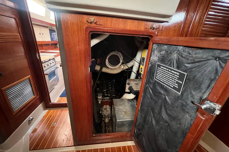 Slide: The Image of Engine compartment of 1985 C&C Landfall 39 sailboat with wooden interior. - 42