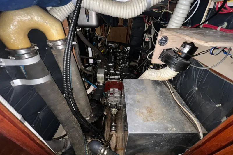 Slide: The Image of Engine room of a 1985 C&C Landfall 39 sailboat with visible components and wiring. - 43