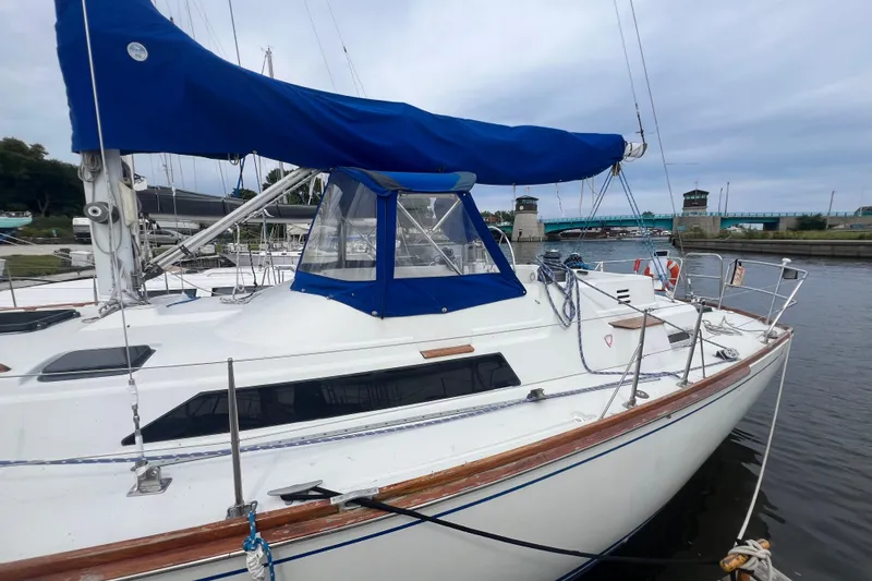 Slide: The Image of 1985 C&C Landfall 39 sailboat docked, featuring blue sail cover and sleek design. - 5