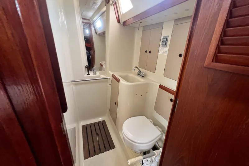 Slide: The Image of 1985 C&C Landfall 39 yacht bathroom with sink, toilet, and wooden accents. - 50